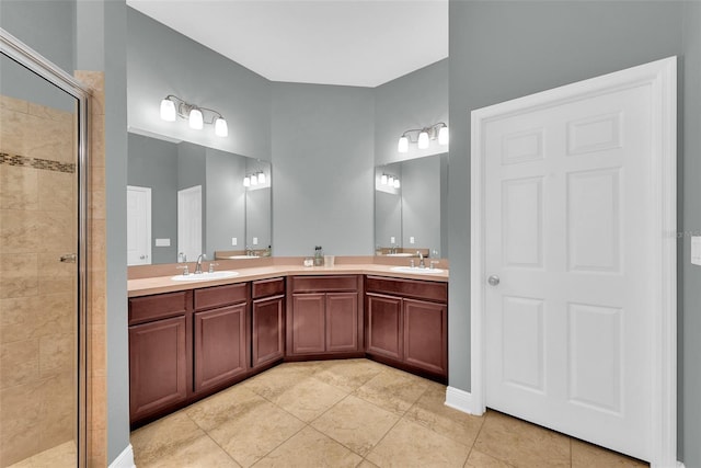 full bathroom with tile patterned flooring, a sink, double vanity, and a stall shower