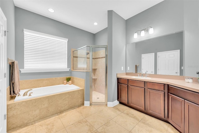 bathroom with a shower stall, a garden tub, vanity, and tile patterned flooring