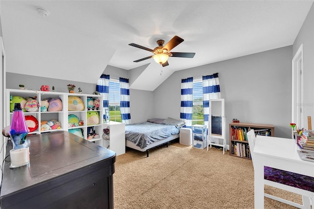 carpeted bedroom with lofted ceiling and a ceiling fan