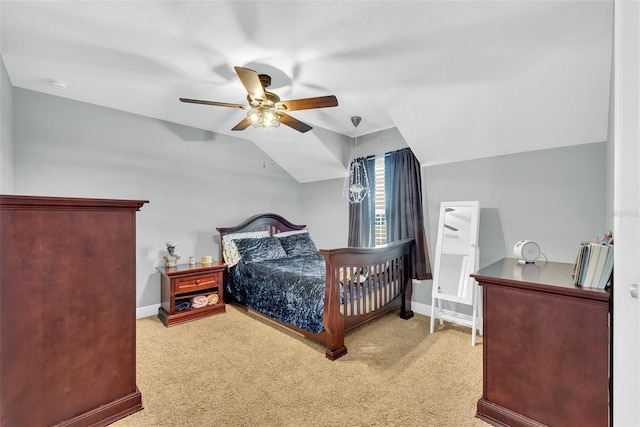 bedroom with vaulted ceiling, carpet flooring, and baseboards