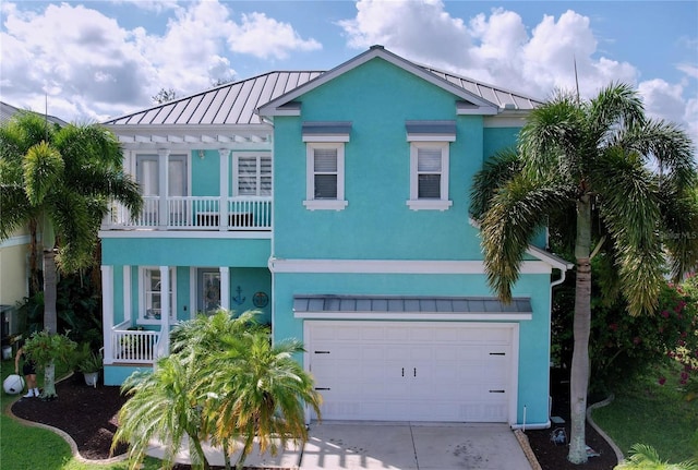 view of front facade featuring a balcony and a garage