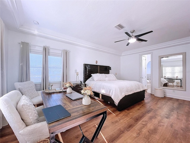 bedroom with ornamental molding, ceiling fan, hardwood / wood-style flooring, and multiple windows