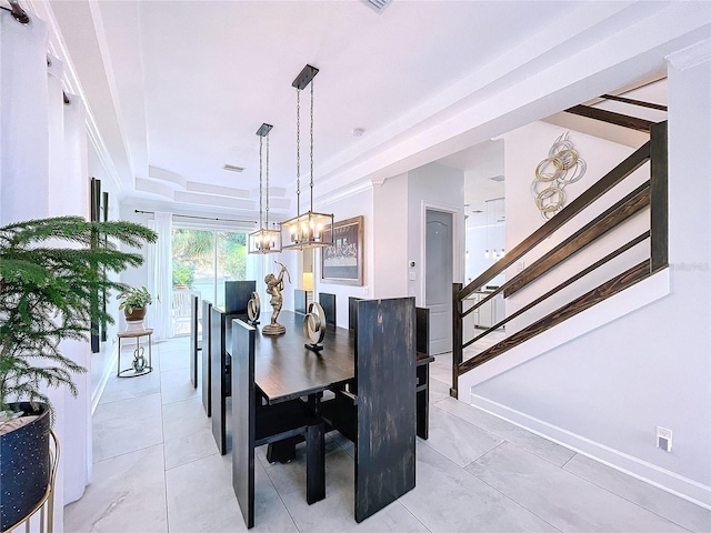 dining area featuring a raised ceiling