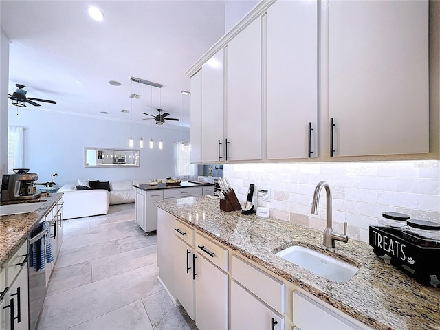 kitchen with white cabinets, dishwasher, hanging light fixtures, and sink