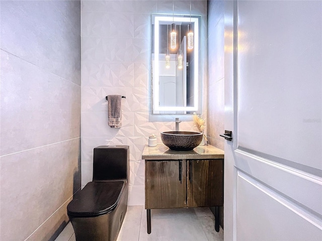 bathroom featuring tile walls, tile patterned flooring, vanity, and toilet