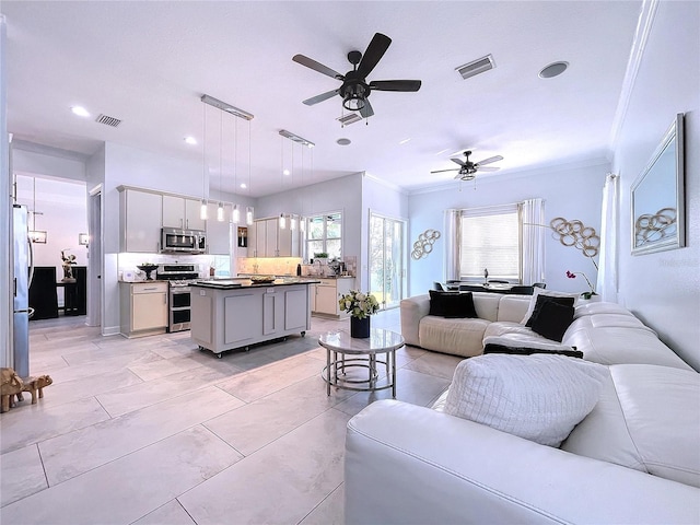 living room featuring ceiling fan and crown molding