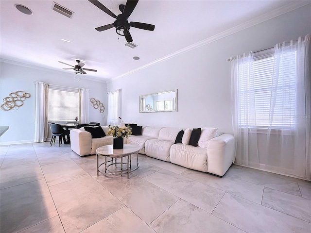 living room with ornamental molding and ceiling fan