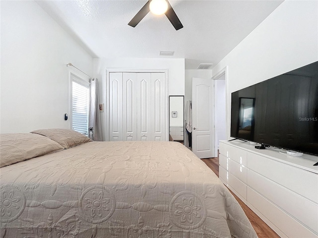 bedroom featuring ceiling fan, a closet, and hardwood / wood-style floors