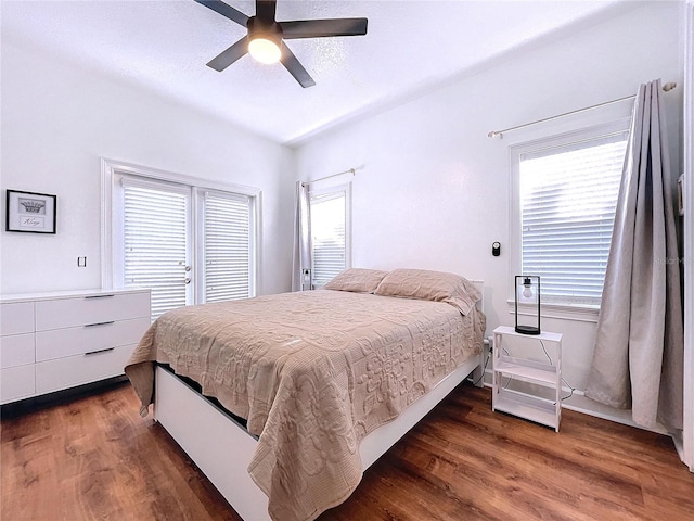 bedroom with dark hardwood / wood-style floors and ceiling fan