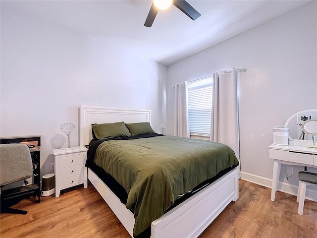 bedroom with ceiling fan, light hardwood / wood-style flooring, and vaulted ceiling