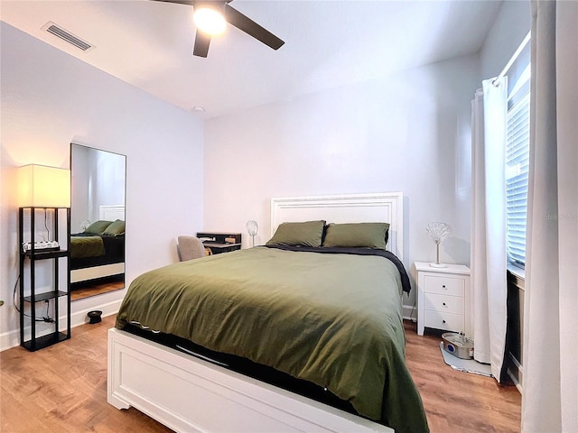 bedroom with light hardwood / wood-style floors and ceiling fan