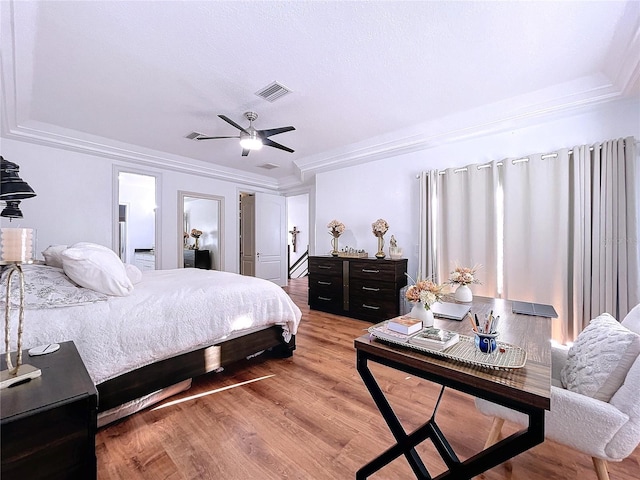 bedroom with crown molding, ceiling fan, and hardwood / wood-style flooring