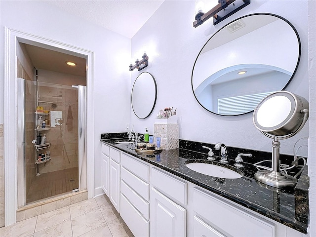 bathroom featuring tile patterned flooring, vanity, and an enclosed shower