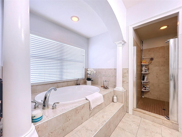 bathroom with separate shower and tub, decorative columns, and tile patterned floors