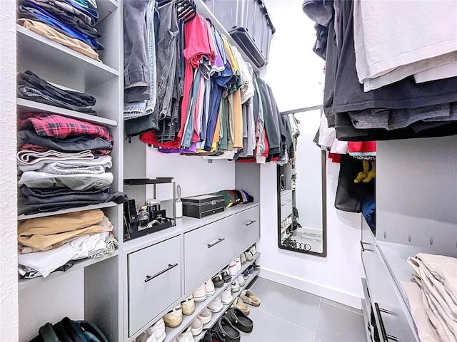 walk in closet with tile patterned flooring