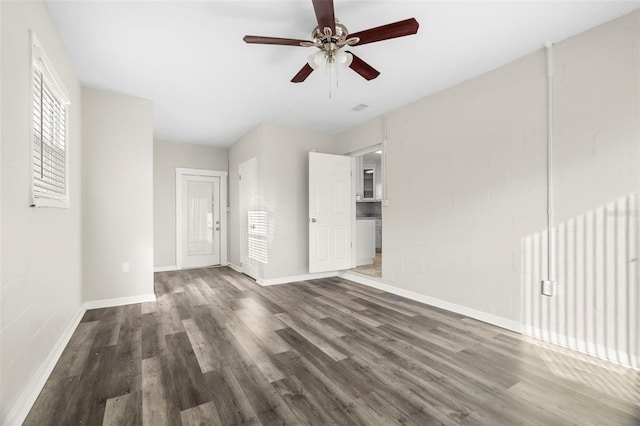 empty room featuring ceiling fan and dark hardwood / wood-style flooring