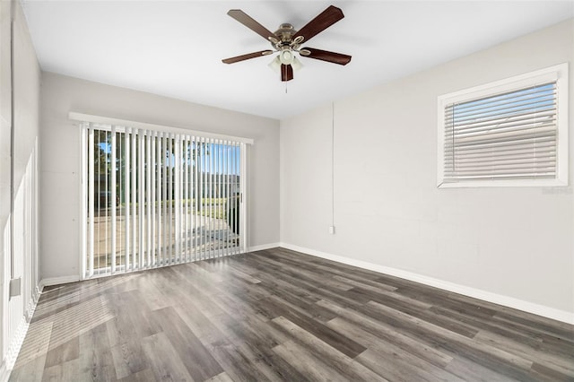 empty room with ceiling fan, a healthy amount of sunlight, and dark hardwood / wood-style floors