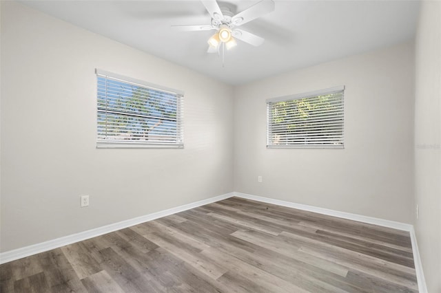 spare room featuring plenty of natural light, light hardwood / wood-style floors, and ceiling fan