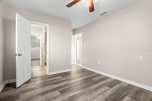 unfurnished bedroom with ceiling fan and dark hardwood / wood-style floors