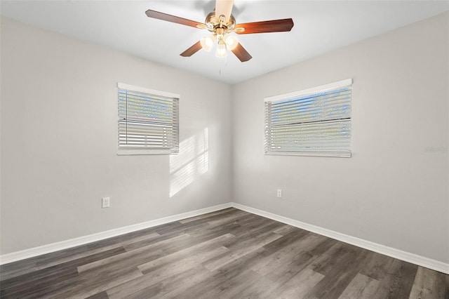 unfurnished room featuring dark hardwood / wood-style floors, a wealth of natural light, and ceiling fan