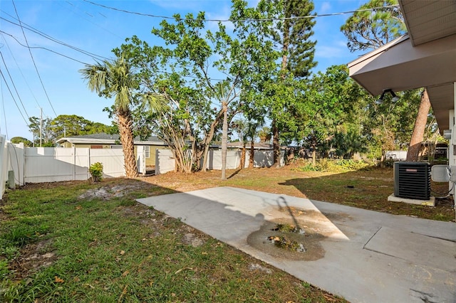 view of yard featuring cooling unit, a patio, and a shed