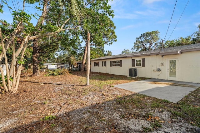 rear view of house with a patio and central air condition unit