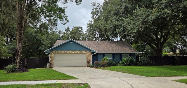 single story home featuring a garage and a front yard