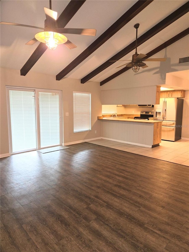 unfurnished living room featuring lofted ceiling with beams, wood-type flooring, and ceiling fan