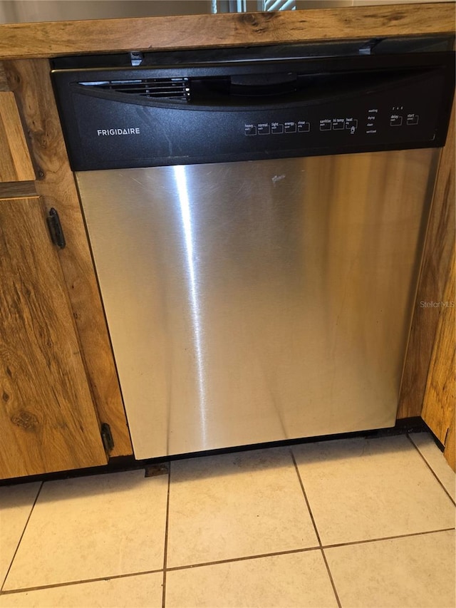 room details with tile patterned floors and stainless steel dishwasher