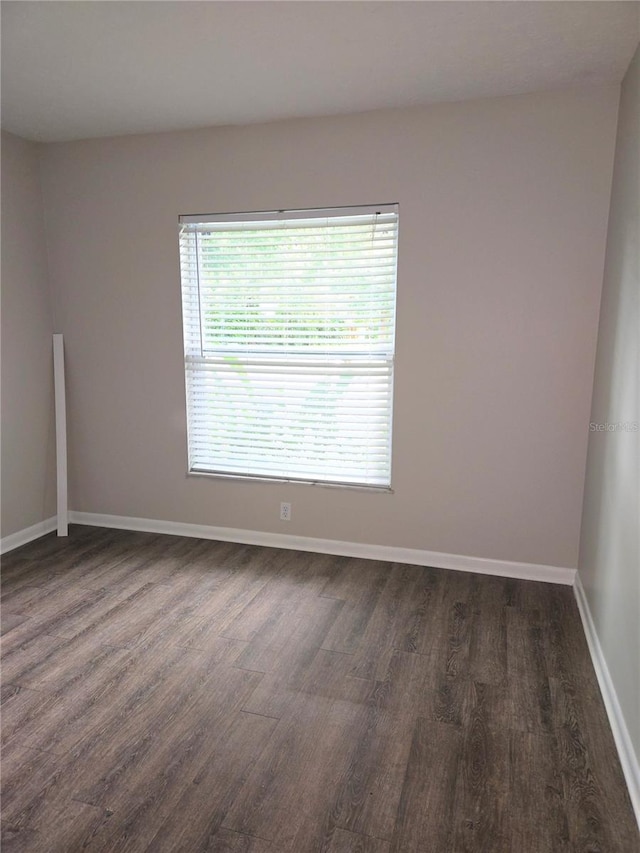 empty room featuring dark hardwood / wood-style flooring