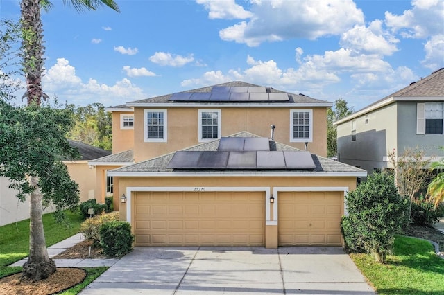 view of front facade featuring solar panels and a garage