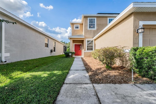 property entrance featuring a lawn and a garage