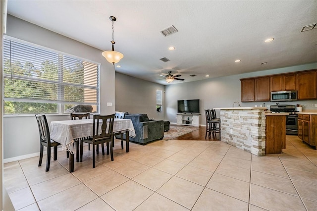 tiled dining room featuring ceiling fan