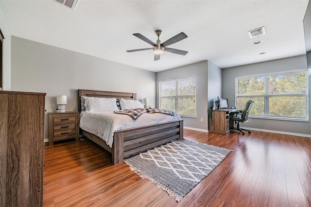 bedroom featuring ceiling fan and dark hardwood / wood-style flooring