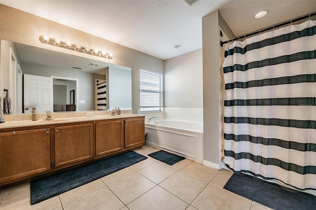 bathroom with plus walk in shower, tile patterned floors, a textured ceiling, and vanity