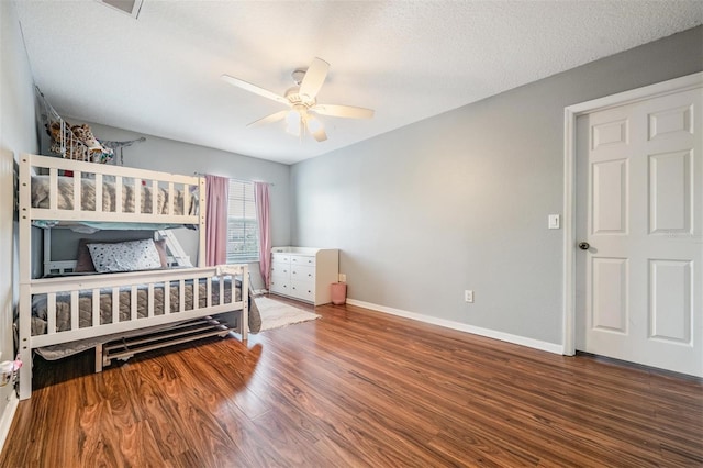 bedroom featuring wood-type flooring, ceiling fan, and a textured ceiling