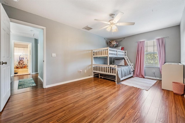 bedroom with ceiling fan and hardwood / wood-style floors