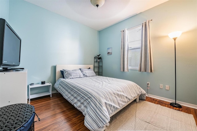 bedroom with ceiling fan and dark hardwood / wood-style floors