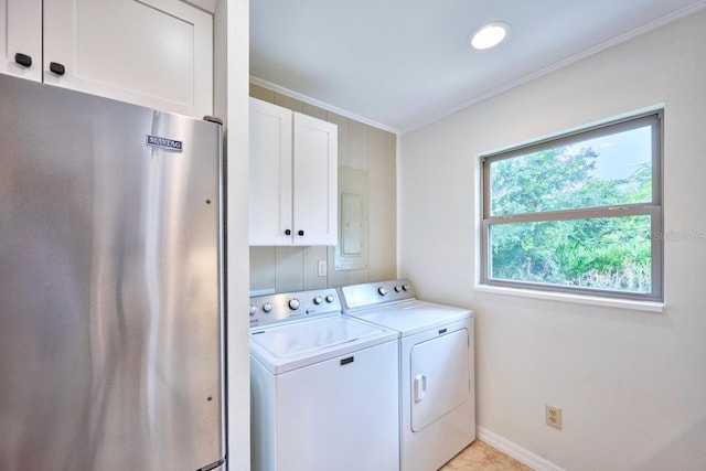 washroom with separate washer and dryer, crown molding, and cabinets