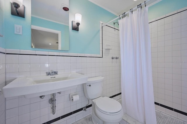 bathroom with crown molding, toilet, tile walls, and a shower with curtain