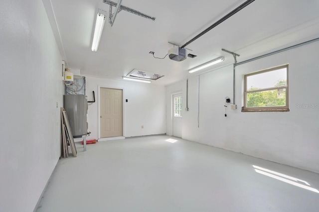 garage featuring a garage door opener and electric water heater