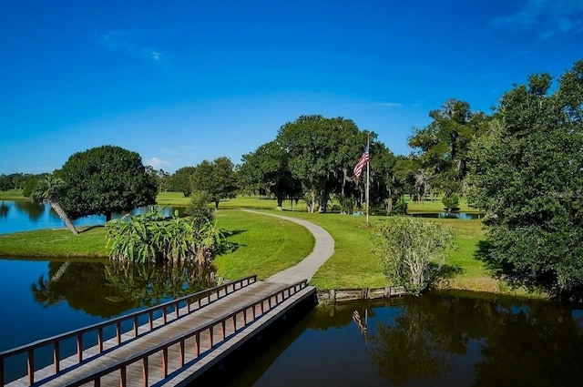 view of community with a yard and a water view