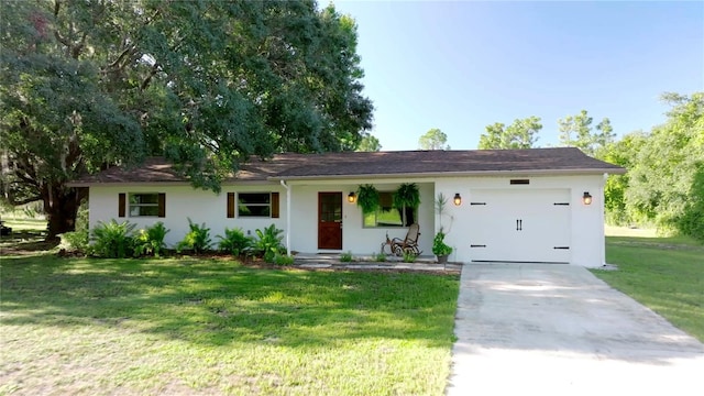 ranch-style house with a garage, stucco siding, concrete driveway, and a front lawn