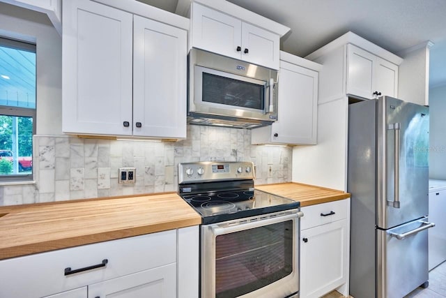 kitchen featuring wood counters, backsplash, appliances with stainless steel finishes, and white cabinets