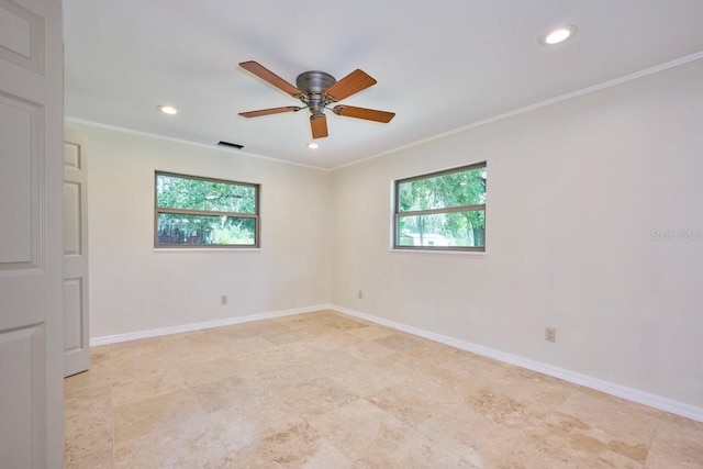 empty room featuring plenty of natural light, baseboards, visible vents, and ornamental molding