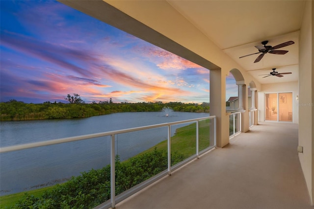 43 Bayview Ct S # A, Saint Petersburg, FL 33711 - balcony at dusk featuring a water view and a ceiling fan
