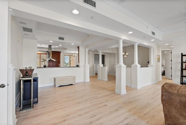 43 Bayview Ct S # A, Saint Petersburg, FL 33711 - unfurnished living room with ornamental molding, light wood-style flooring, recessed lighting, baseboards, and decorative columns