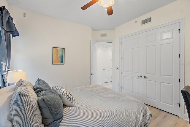 43 Bayview Ct S # A, Saint Petersburg, FL 33711 - bedroom featuring light wood-type flooring, a closet, and a ceiling fan