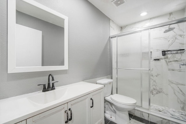 bathroom with walk in shower, vanity, and toilet