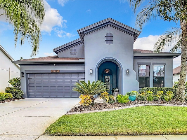 view of front of home featuring a front lawn and a garage